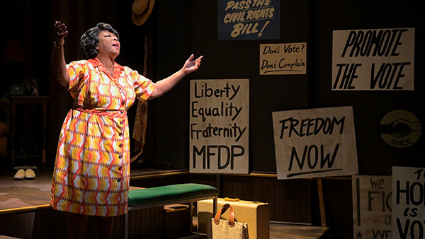 Greta Oglesby as civil rights activist Fannie Lou Hamer gestures to the sky while singing.