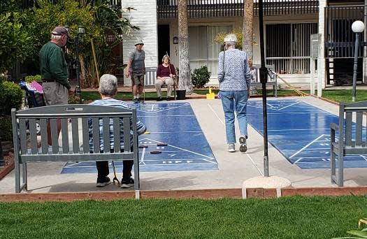 Photo of seniors playing shuffle board at Fellowship Square Tucson