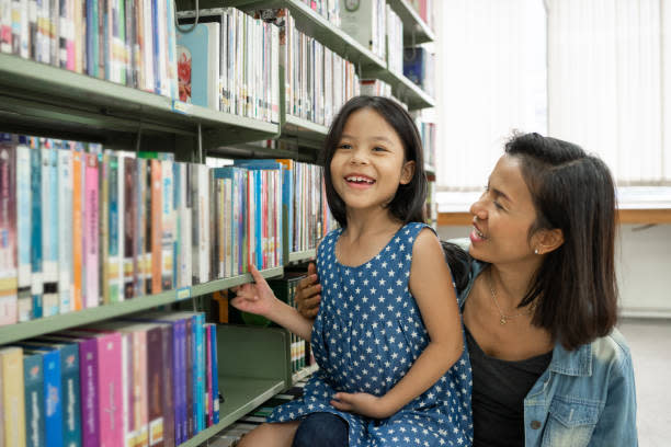 mom with daughter at library