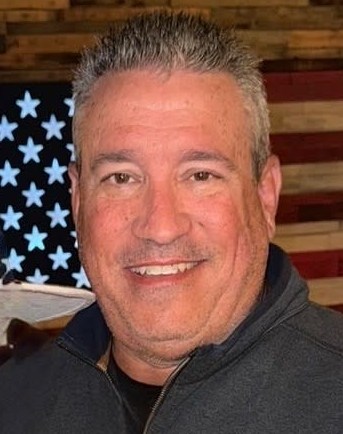 Scott Chronister profile with American Flag in the background