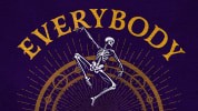 Against a dark purple background is a tarot-card style image of a skeleton dancing in front of a golden wheel of fortune that