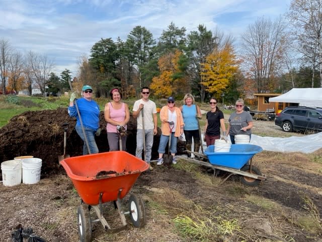 people with wheel barrows and tools