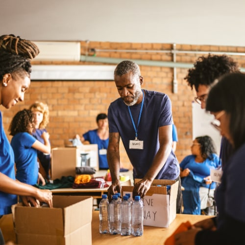 Volunteers pack food and supplies for their neighbors.