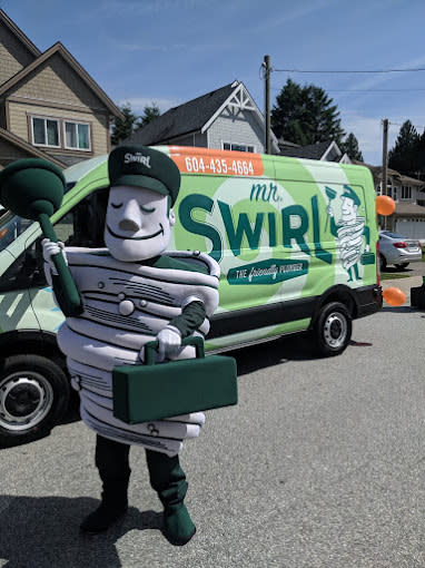 Mr Swirl The Friendly Plumber mascot standing beside a Mr Swirl service van