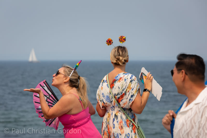 Young women pose for photos during the Alki Beach Pride festival.