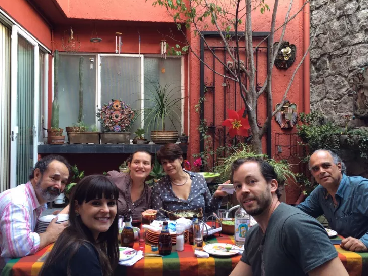 photo of a group of friends eating a fantastic meal in a local chef's home in Mexico