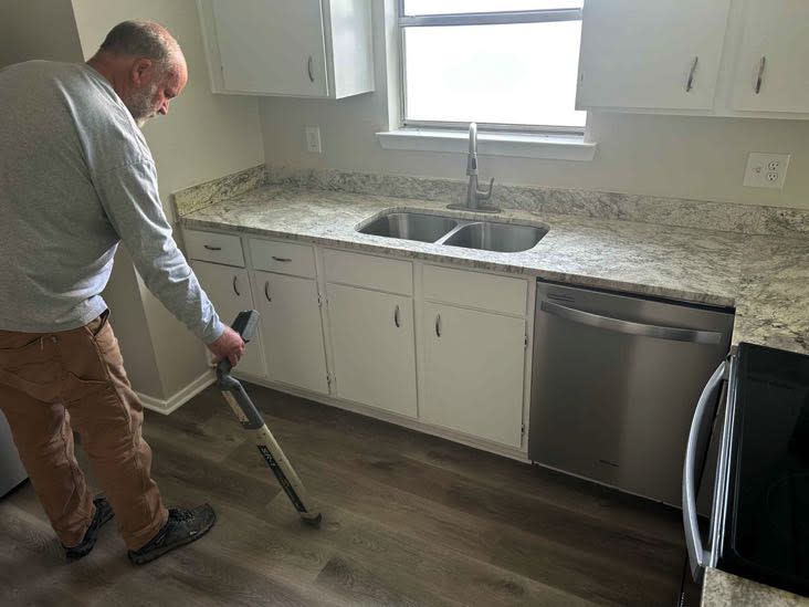 Dave Flynn of SewerTV Hydro Jetting and Plumbing detecting a leak in a kitchen