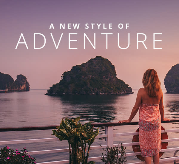 photo of a woman looking at beautiful rocky island from a river cruise