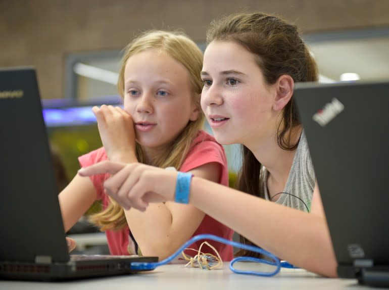 Local high school students teaching technology class to middle schoolers