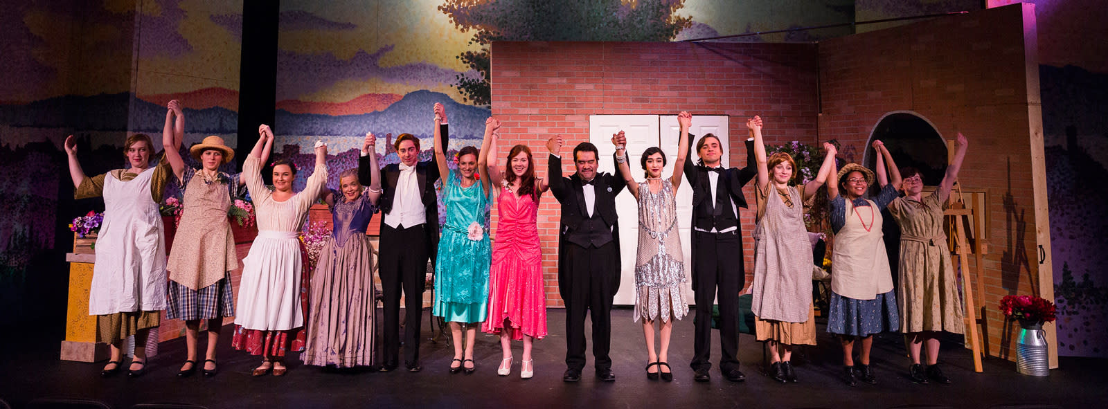 a cast of college students taking a company bow