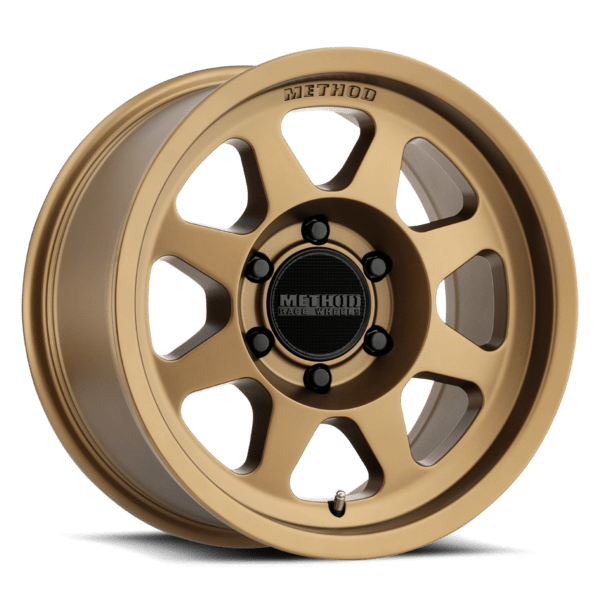 Bronze colored wheel with 8 spokes and a black hub cap with black lug nuts