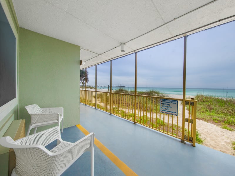 front porch of a hotel room stepping directly onto the beach