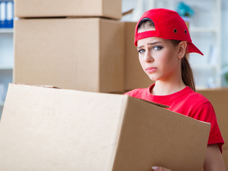 Young woman carrying boxes, symbolizing "Do You Know What You're Buying?"