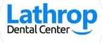 Dentist at Lathrop Dental Center examining a patient’s teeth in a modern dental office.