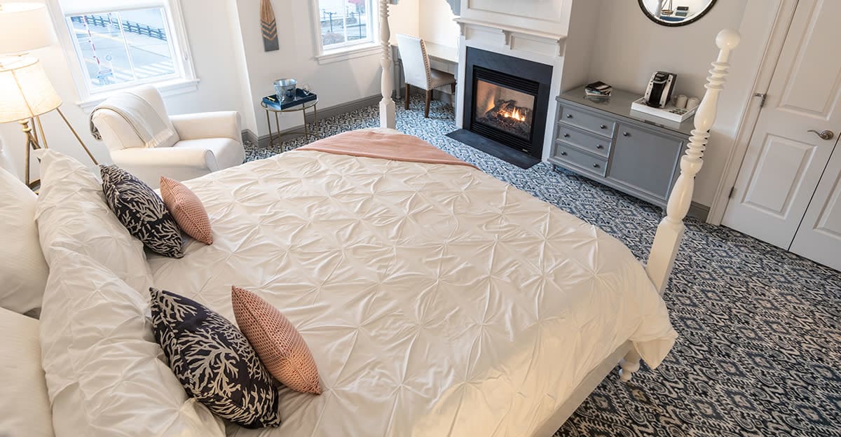Hoxie House hotel bed and gas-lit fireplace in Downtown Mystic