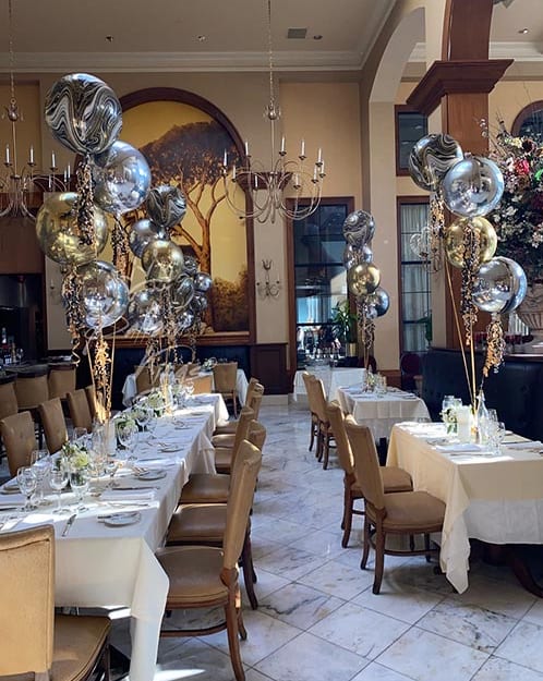 Elegant balloon centerpieces in silver and gold for upscale Dallas restaurant event by Balloon Kings.