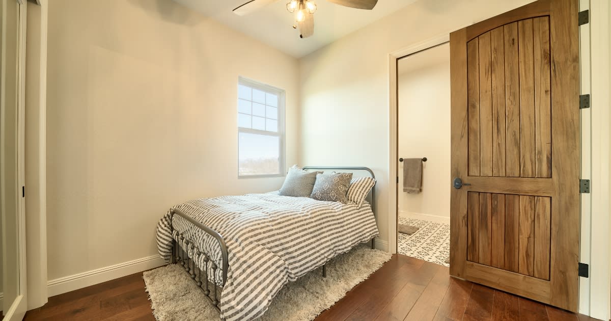 Rustic wood door in a bedroom of a Fallbrook home. This solid, sturdy door is both stylish and practical.