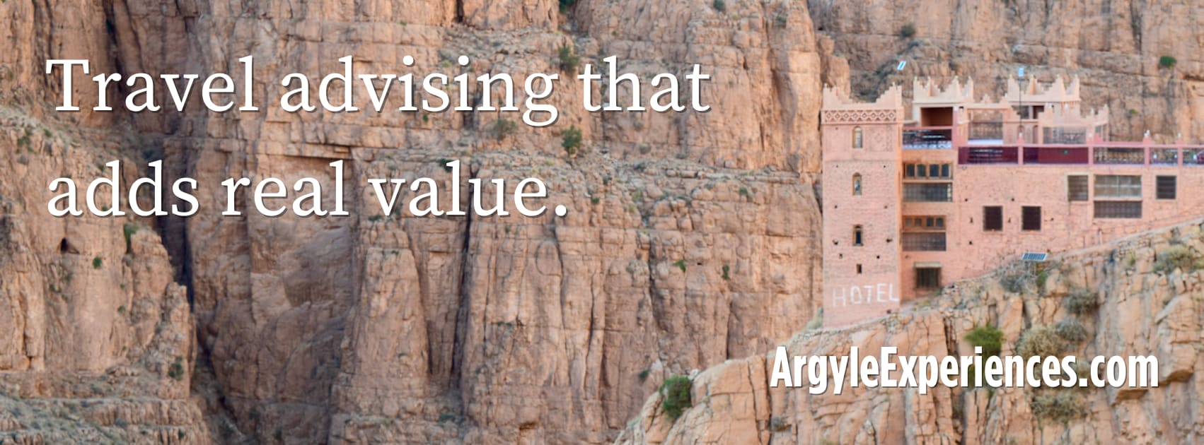 hotel perched on a cliff with the words "travel advising that adds real value."