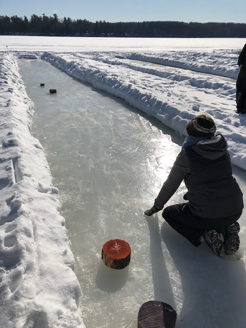 Participant throwing the puck down the lane