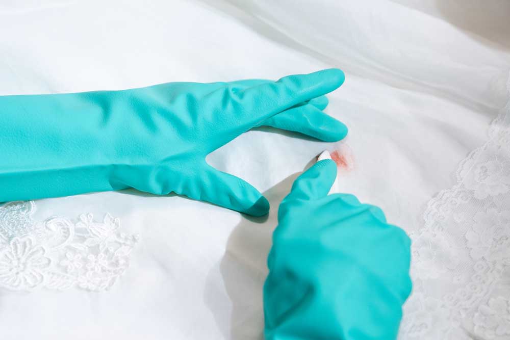 Gently removing a stain on a wedding gown