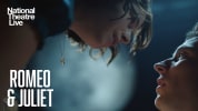 National Theatre Live: Romeo and Juliet. A woman on the top right corner looking down to a man on the lower left corner in a