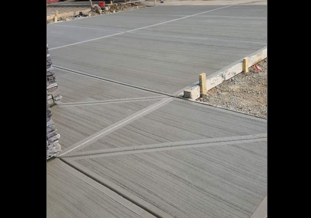 Concrete driveway and sidewalk, forming, pouring and landscaping.
