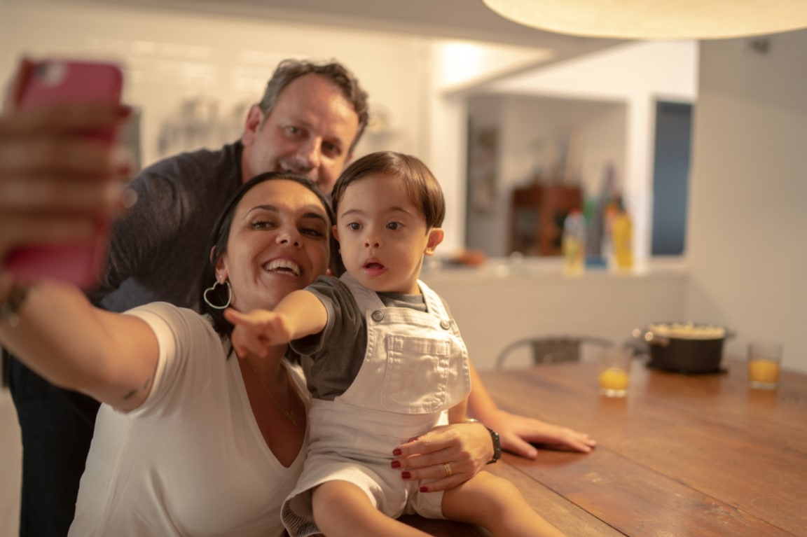 young family takes a selfie in a home setting