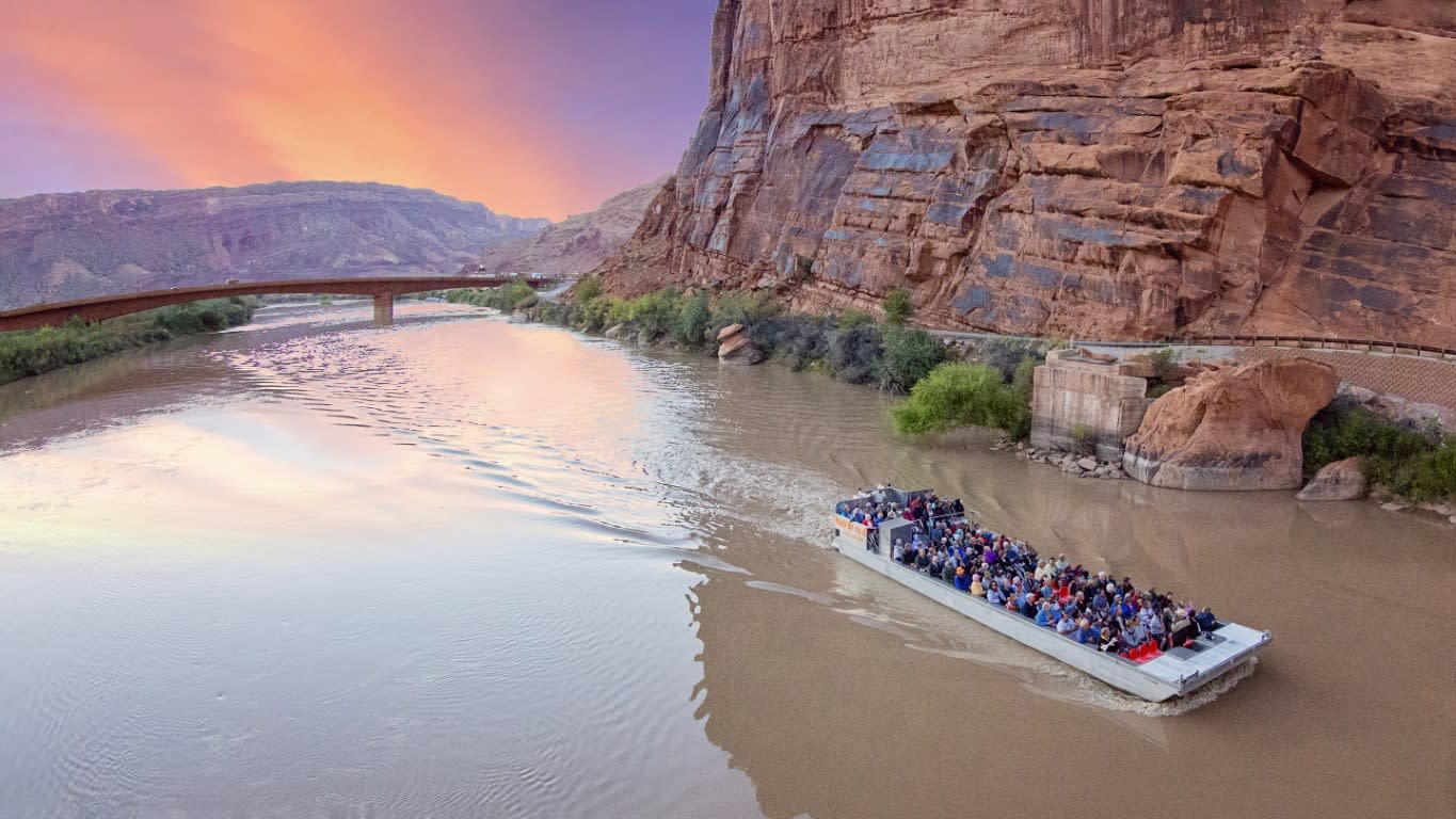 Smooth Colorado River reflecting canyon wall lights during the Moab Sound and Light Show