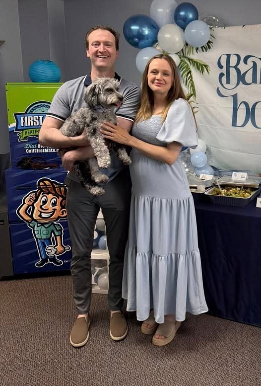 First Mate Heating & Cooling family owners, Tom and Anna, with puppy Ace