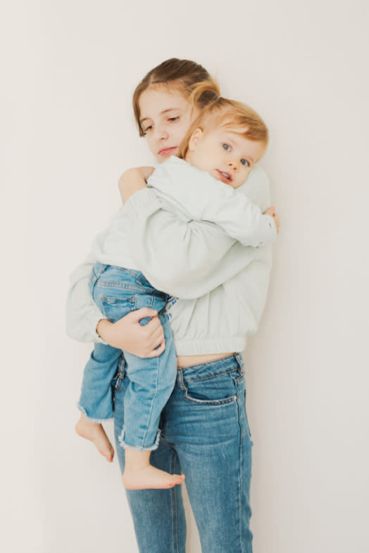 two sisters holding each other