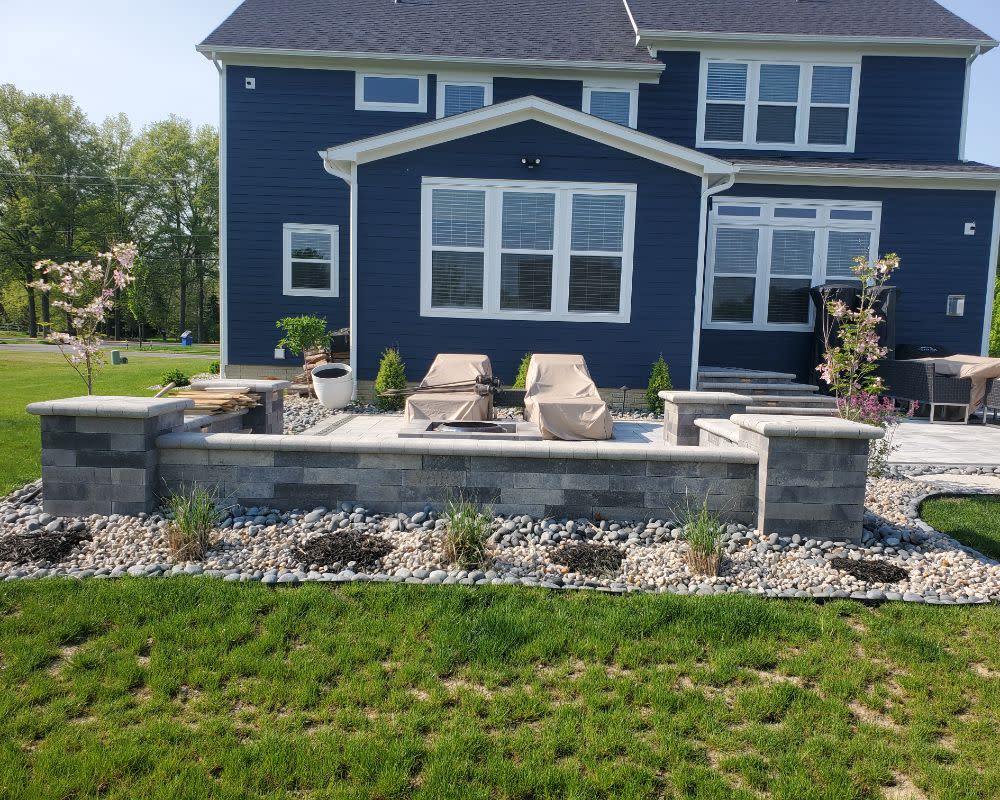Backyard Patio With Seatwall And Surrounding Low Maintenance Garden Beds