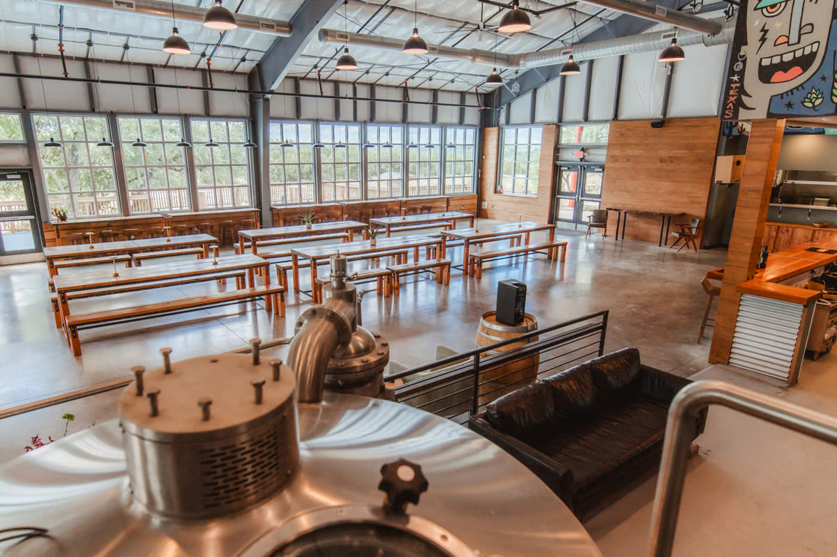 Beerburg tap room, seen from atop the brewing platform, beer-hall style tables + wall-to-wall windows