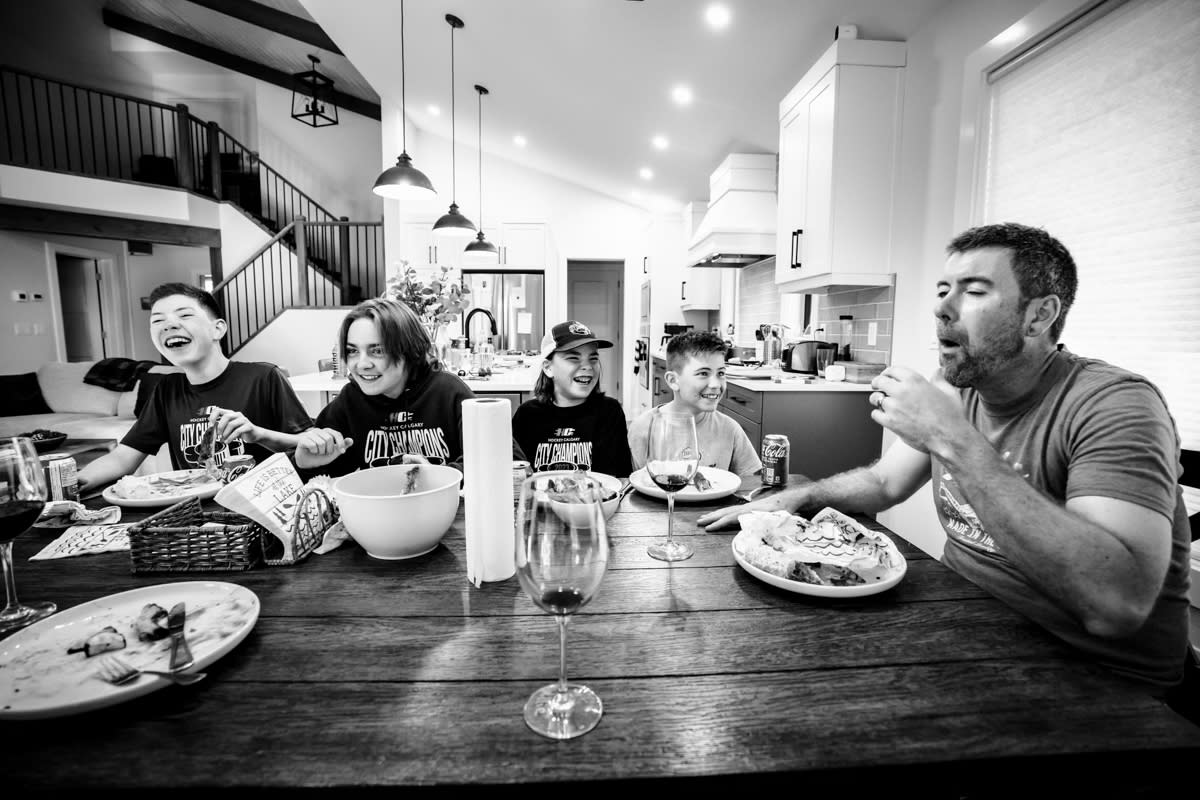 documentary photograph of 4 boys laughing as Dad tells his "fart story"
