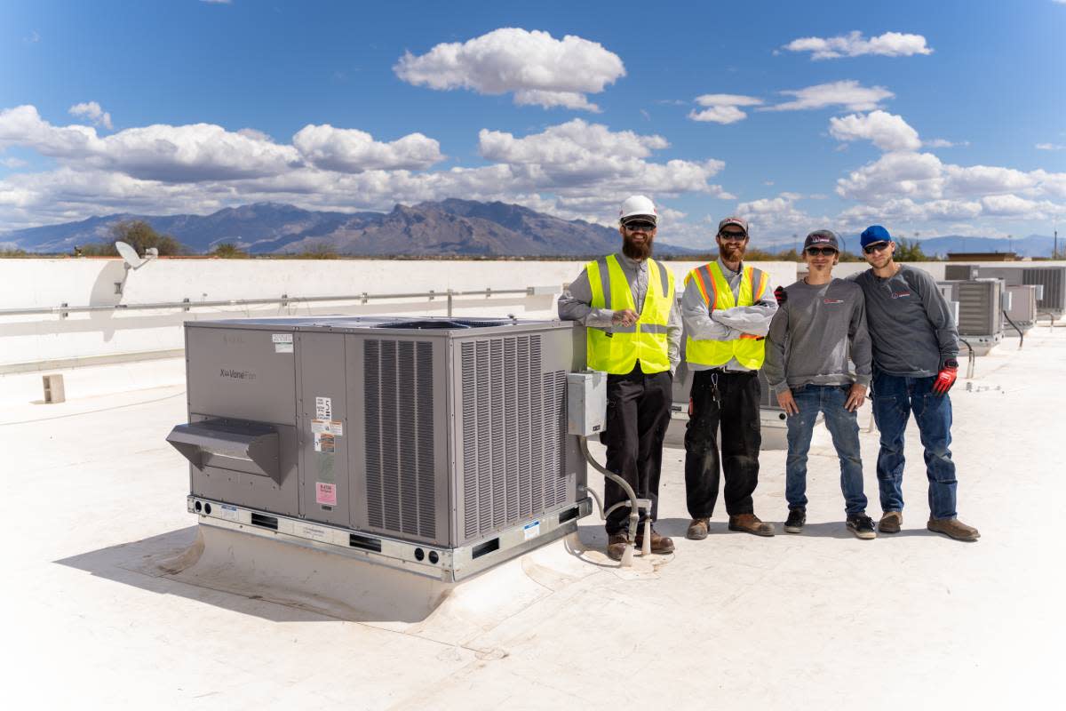 Done Rite Services team after a successful rooftop AC installation.
