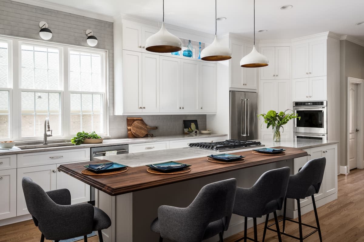 White kitchen with warm wood accents in the Ballantyne area of Charlotte, NC by Distinctive Design + Build + Remodel.