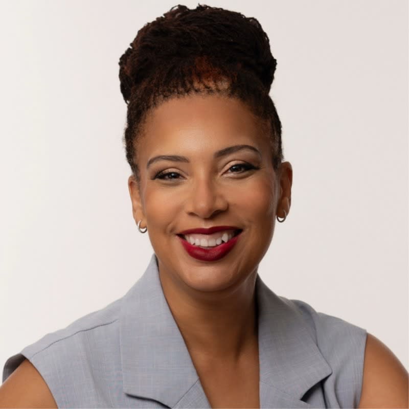 A smiling woman looking directly at the camera