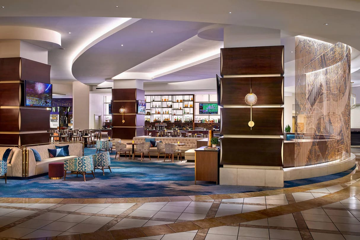 Photo of New Orleans Marriott lounge, mixed seating includes banquettes, arm chairs, & bar stools, bar on back wall