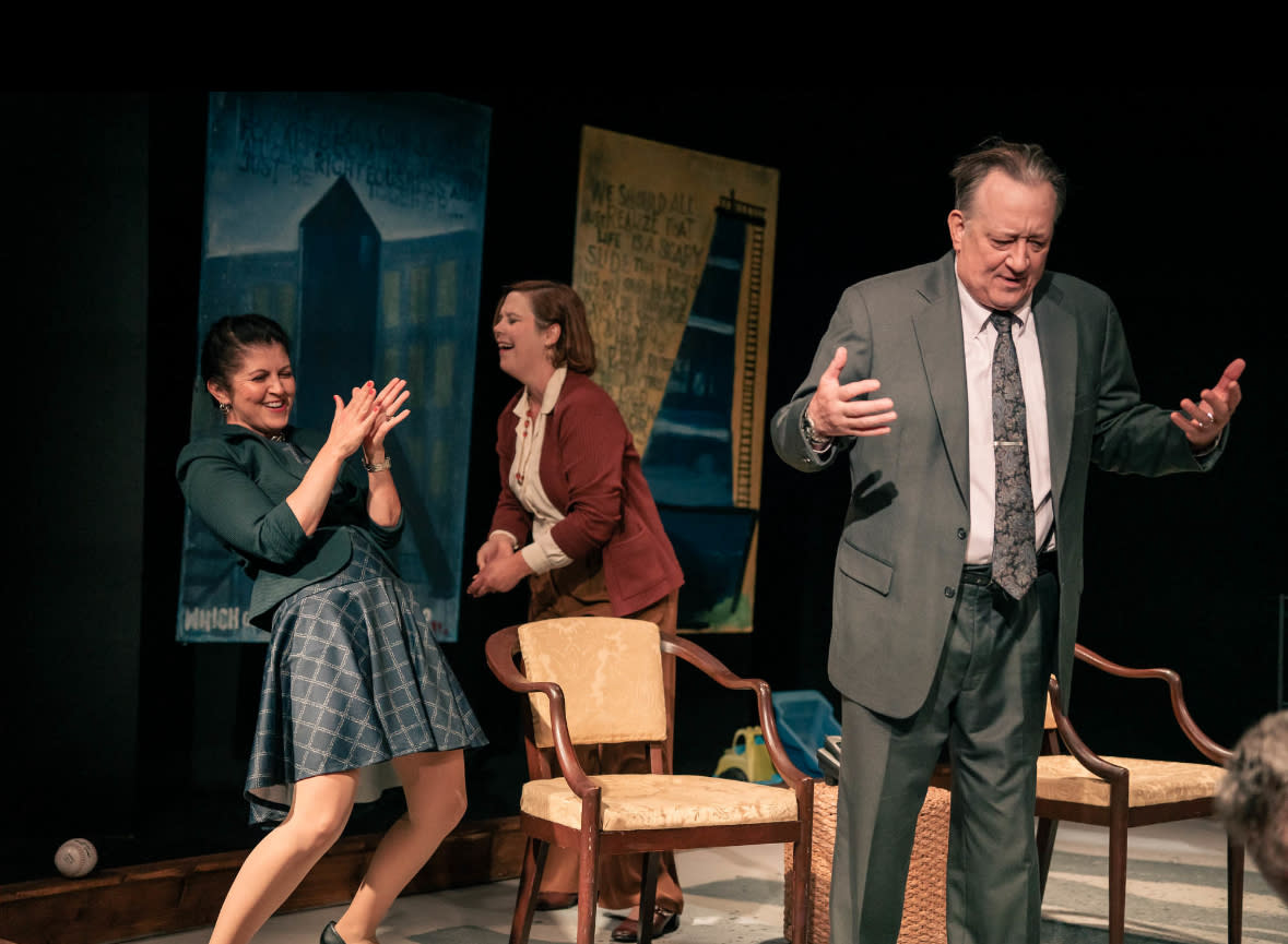 Image shows Alan looking miserable while Annette and Veronica cheer