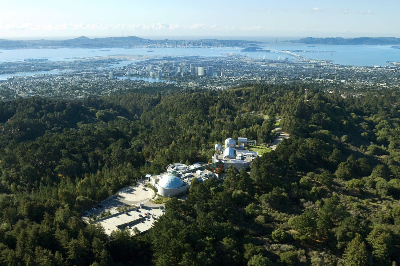 Aerial shot of Chabot Space and Science Center nestled in the wooded Oakland hills.