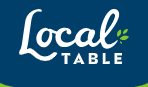 Interior view of Local Table Restaurant featuring a warm, modern dining area with guests enjoying fresh, locally sourced meal