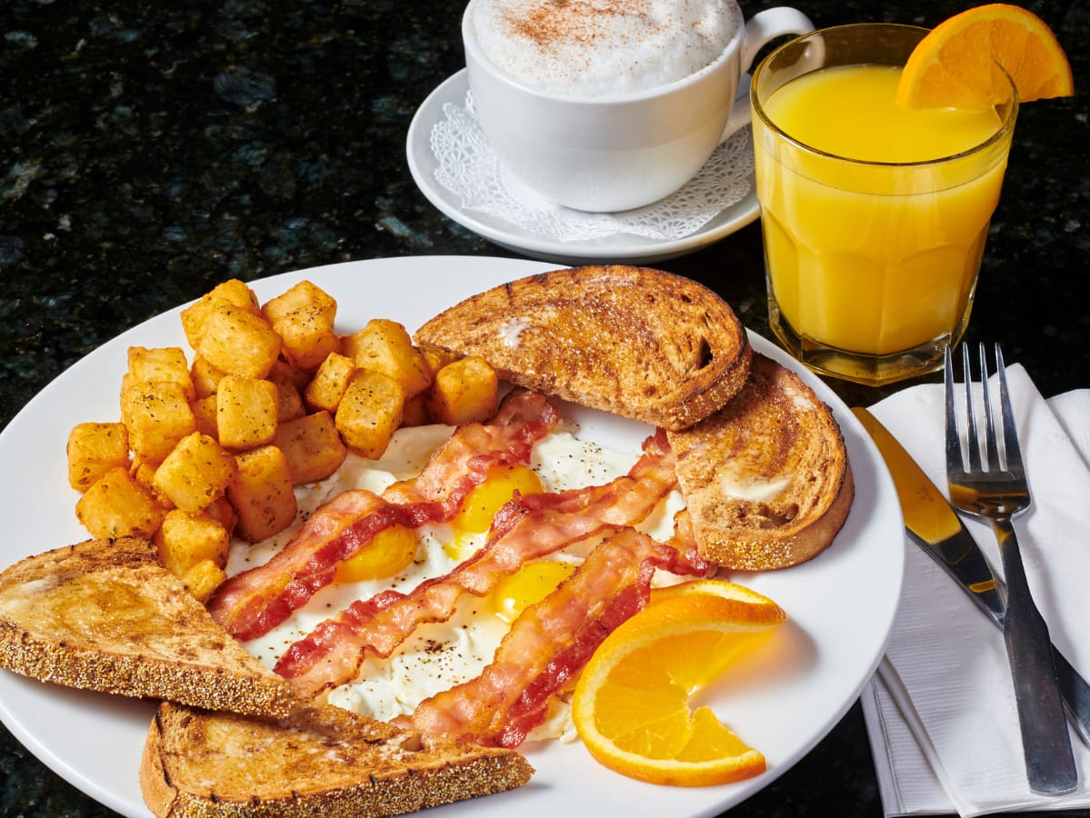 3 egg Early Bird Breakfast with breakfast potatoes adding refreshing orange juice and hot cappuccino