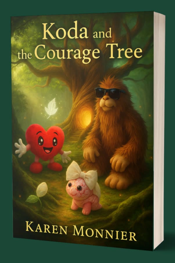 Book cover of “Koda and the Courage Tree” showing Koda the Bigfoot wearing sunglasses, Arty the red heart character, and Luna