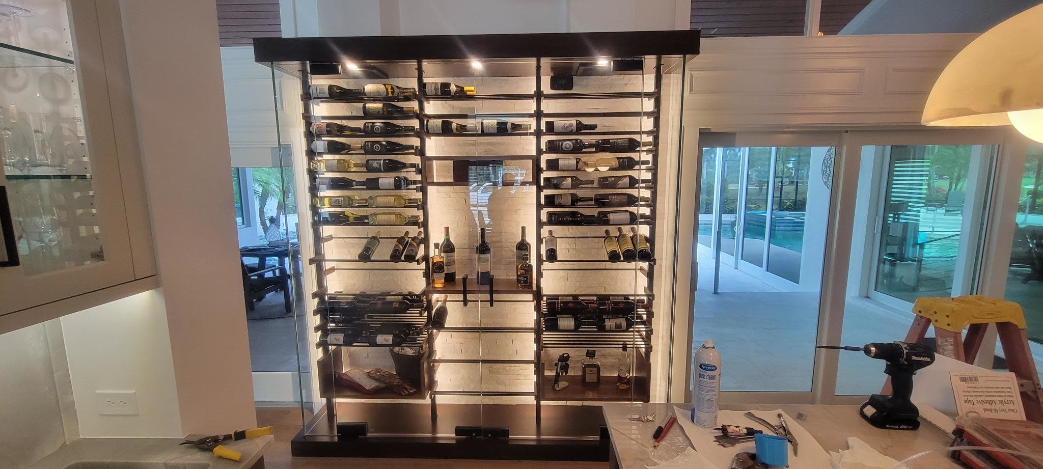 Frameless glass wine enclosure, sleek timeless, hidden hardware, premium racking.