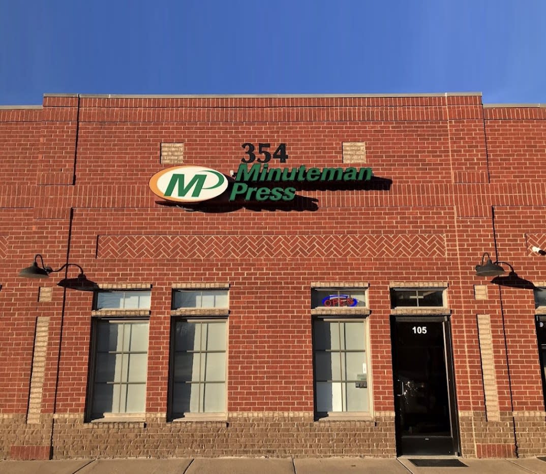 red brick building with Minuteman Press sign at 354 Downs Blvd, Ste 105