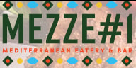 A colorful spread of Mediterranean dishes including hummus, falafel, kebabs, and fresh salads at Mezze #1 Restaurant.