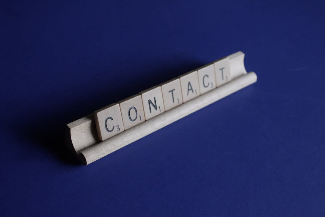 scrabble game tiles of letters that say Contact