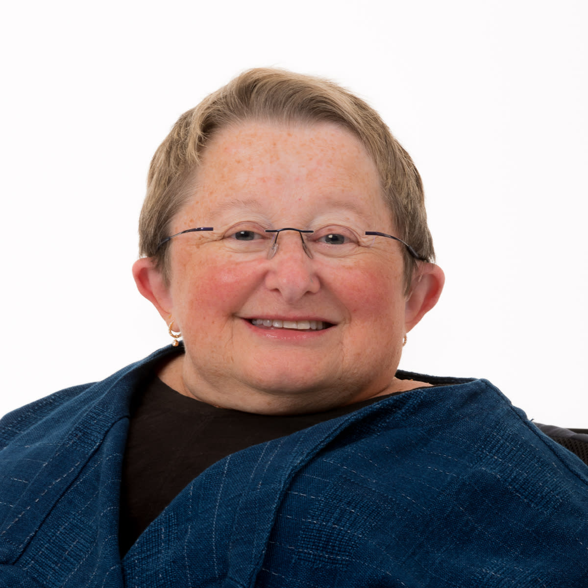 Karen is wearing a blue blazer over a black top