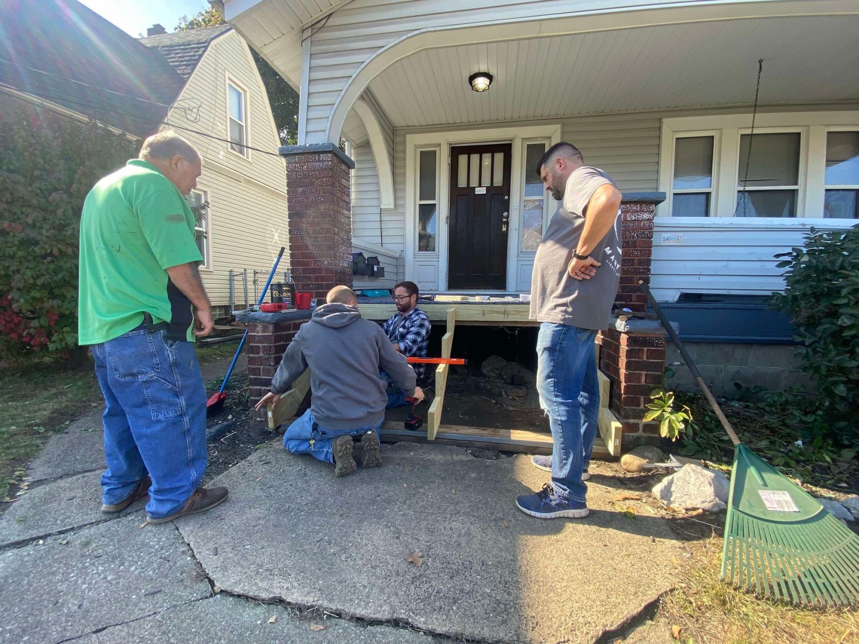Rebuilding a staircase during a volunteer day with House of Hope