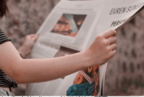 person reading newspaper