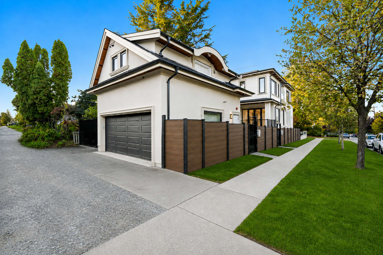 Laneway home at 3833 Highbury featuring a two-storey design, private garage, white exterior, black trim, wood accents and lan